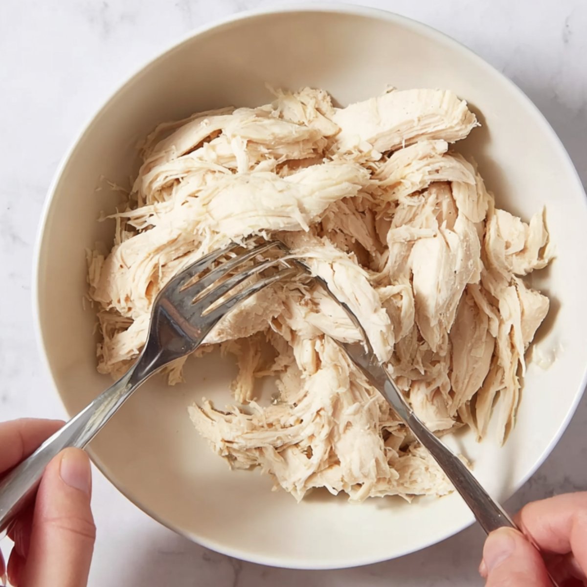 Shredding chicken for homemade chicken noodle soup.