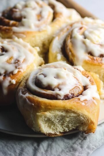 Soft, warm Sourdough Cinnamon Rolls with a creamy glaze, freshly baked and ready to be enjoyed.