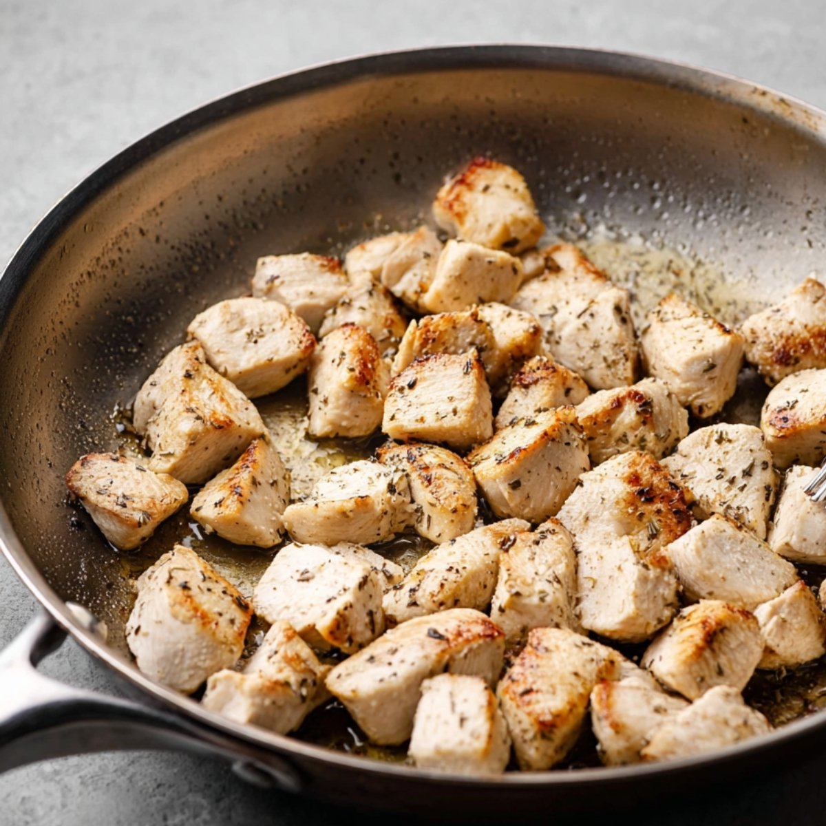Chunks of chicken breast are being sautéed to a perfect golden brown in a hot pan, ready to be added to the stir-fry with vegetables.