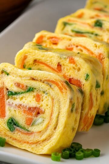 Sliced Gyeran Mari with green onions and carrots.